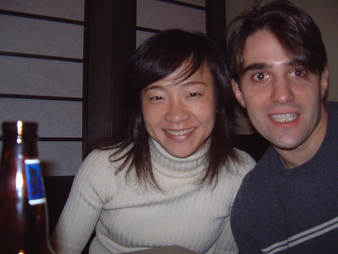 Adam and his wife smiling together at dinner