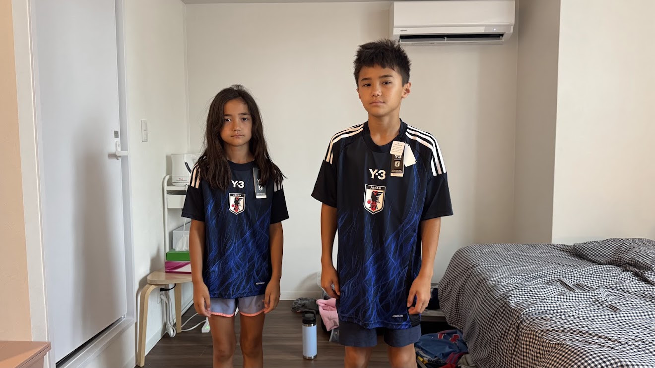 My son and daughter wearing matching blue Japan national team soccer jerseys