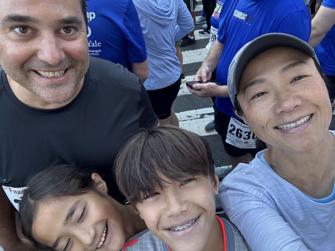 Adam with his family in a selfie at a 5K race